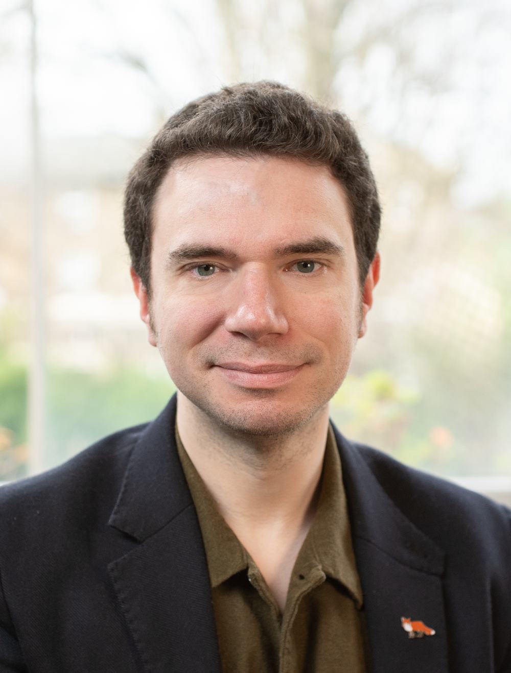 A picture of Matthew Eaves, a man with brown hair and green eyes. The picture is a portrait or head-shot and shows Matthew smiling.