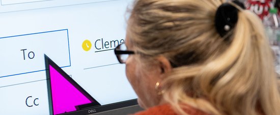 A woman uses magnification software for work.