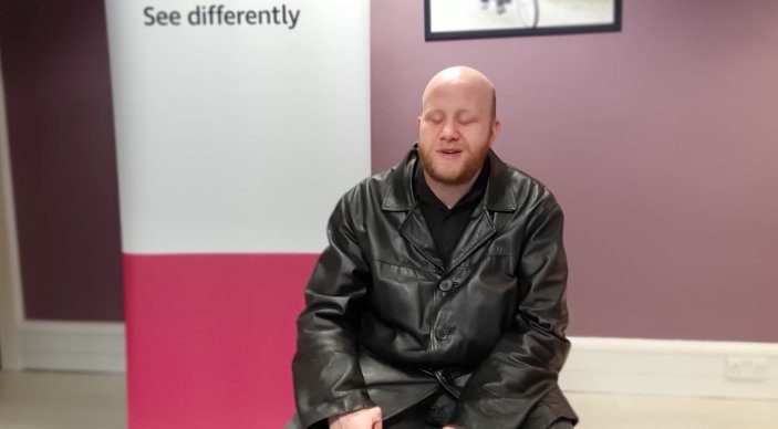 Daniel Thomas sitting in RNIB offices