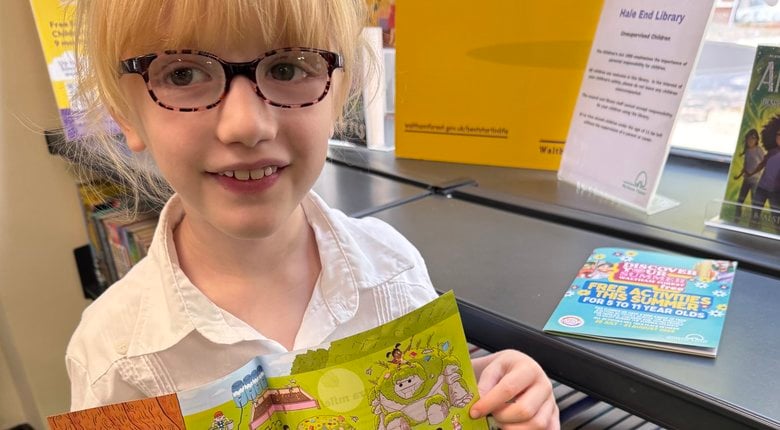 Image shows a child completing reading activities in a library