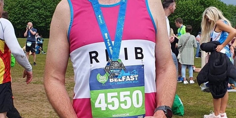Runner Neal Smiling with his medal after taking part in last year's Belfast Marathon.