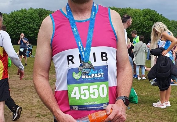 Runner Neal Smiling with his medal after taking part in last year's Belfast Marathon.