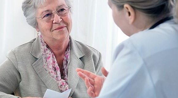 A lady being consulted by her eye specialist.