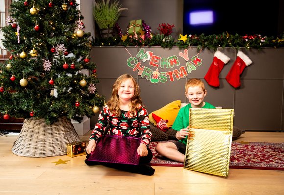 Charlie and Mathilda, two children, holding an accessible letter from santa