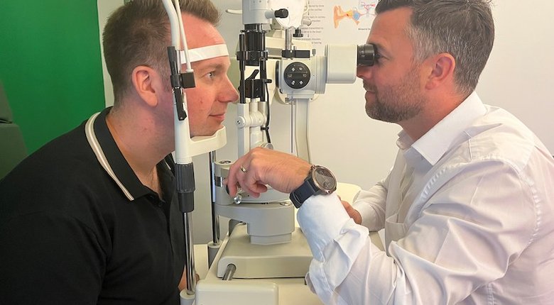 Accountant Philip Campbell (left) having his eyes tested by a local optometrist.