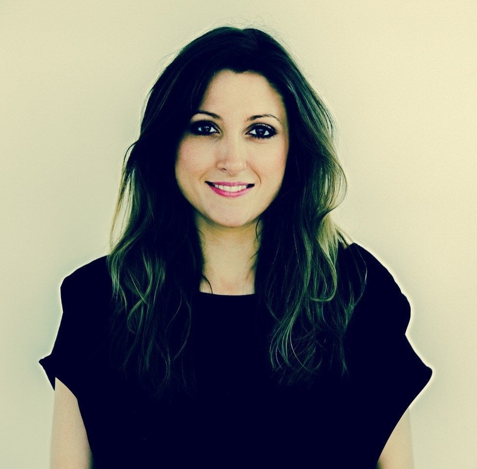 Image shows Sibéal Pounder smiling with long dark hair and wearing a black top